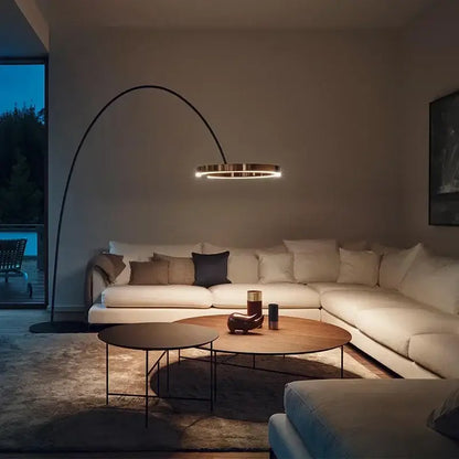 Modern black and gold floor lamp with arched sleek metal frame and illuminated circular luminescence led ring head