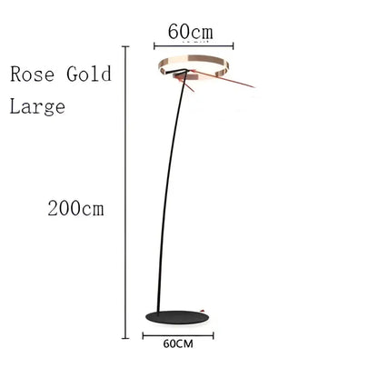Rose gold large floor lamp with sleek curved stem and circular base in decorbites circular luminescence led style