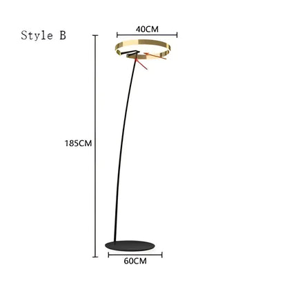 Modern black and gold floor lamp with a circular luminescence led head and sleek curved stem by decorbites circular luminescence