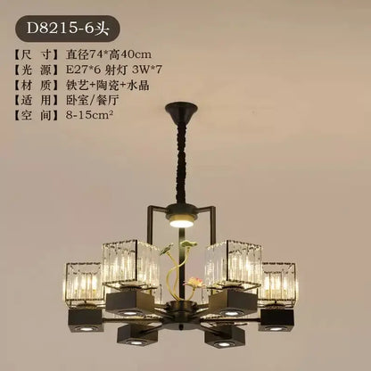 Modern black and gold crystal dining room chandelier with six crystal-encased lights and ceramic lotus decorbites crystal dining