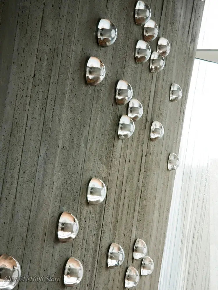 Modern black and gold crystal wall light with silver semi-spherical metallic decorbites crystal wall pieces on concrete