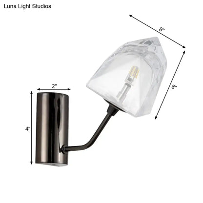 Modern black and gold wall sconce with faceted glass shade featuring bulb base and backplate width details