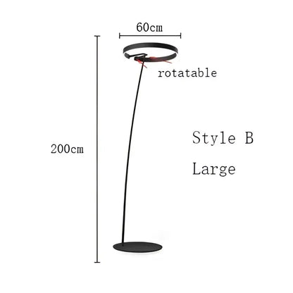Modern black and gold led floor lamp with circular head and slender curved metal base for living room lighting