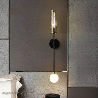 Modern black and gold led wall lamp with metal base and gold-toned slat shade featuring a glowing white bulb for decorbites led wall