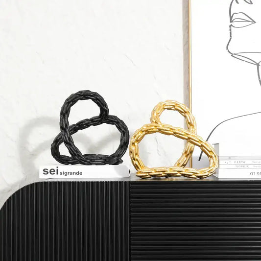 Modern black and golden knot chain sculpture decor featuring twisted golden knot chain design for living room display