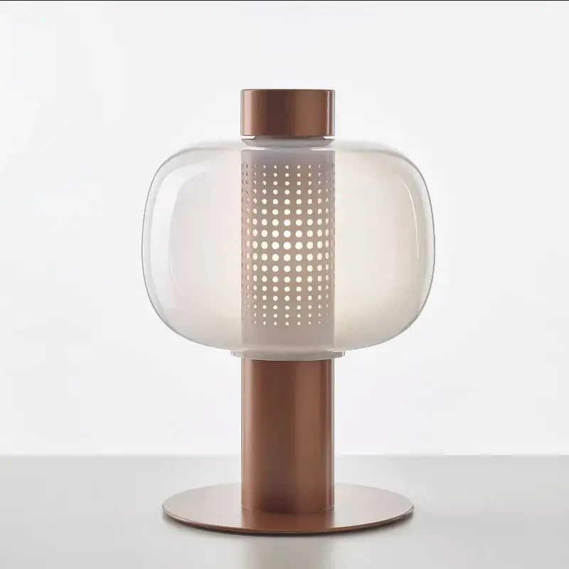 Copper-finished modern black and gray glass table light with rounded translucent shade and perforated panel bedside lamp