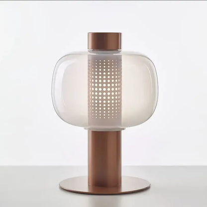 Copper-finished modern black and gray glass table light with rounded translucent shade and perforated panel bedside lamp