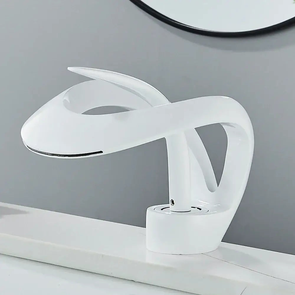 Modern white ceramic waterfall mixer tap basin faucet with sleek sculptural design and minimalist aesthetic