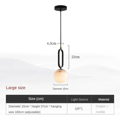 Modern black and polished copper pendant light with a spherical translucent amber glass globe shade for dining room