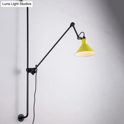 Yellow conical shade wall-mounted lamp with black articulated arm and pipe base for direct wired electric use