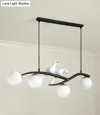 Modern black and white bird linear island pendant light with three white glass shades and sculpted dove figures