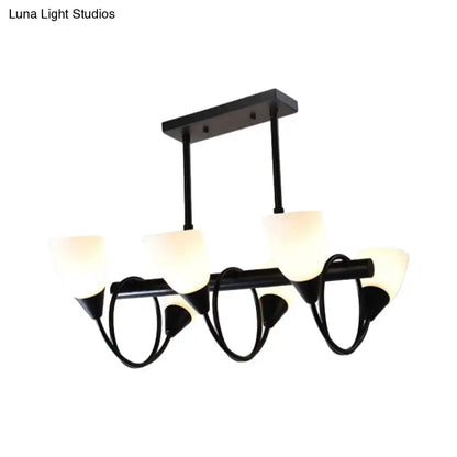 Modern black metal light fixture with five frosted glass shades for use as a kitchen pendant light