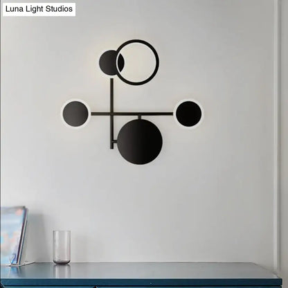 Modern black and white metallic round led wall sconce with minimalist geometric design for living room lighting