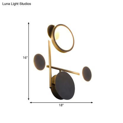 Modern black and white metallic round led wall sconce with gold-toned circular light fixtures and matte black accents