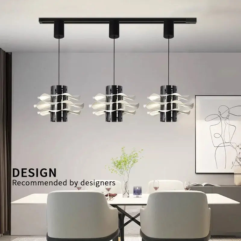 Three modern black and white petal pendant lamps with flowing glass shades hang above a dining table decorbites designer restaurant pendant