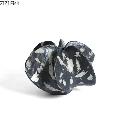 Modern black and white ceramic starfruit coral sculpture with organic leaf-like folds for bedroom decor