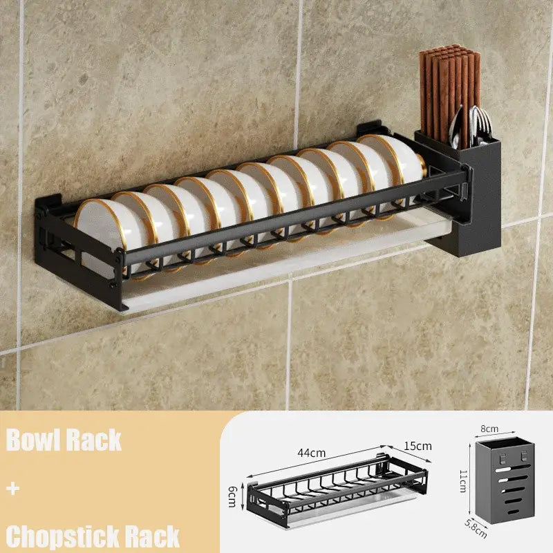 Modern black metal wall-mounted dish drainer rack with two tiers holding white plates with gold rims for kitchen storage