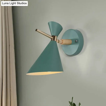 Teal wall sconce with conical angle shade and wooden accents for modern bedroom lighting