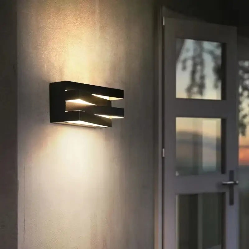 Modern black angular metal wall lamp with layered design emitting warm light ip65 outdoor wall lamp for villa porch