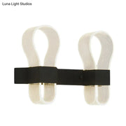 Modern black arc ring wall lamp with two curved off-white acrylic arms and a sleek black metal arc ring sconce design
