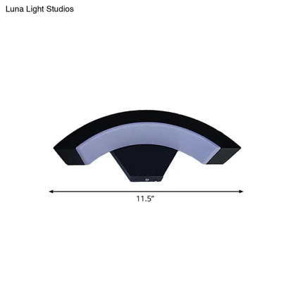 Modern black arc wall sconce with a sleek curved design and integrated soft white led light for bedroom use