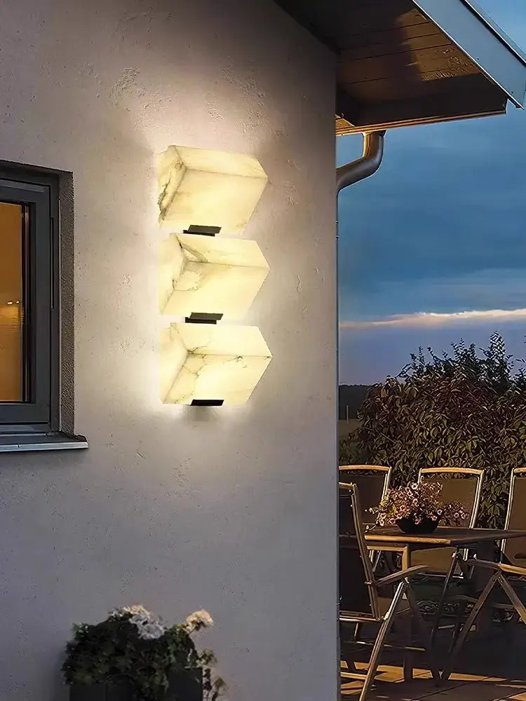 Modern black art deco marble led wall light with three warm glowing white marble panels for bedroom decorbites art deco