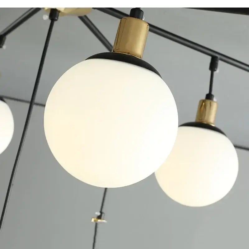 Modern black art glass ball molecule chandelier with frosted white glass shades and polished brass accents for living room decorbites art glass