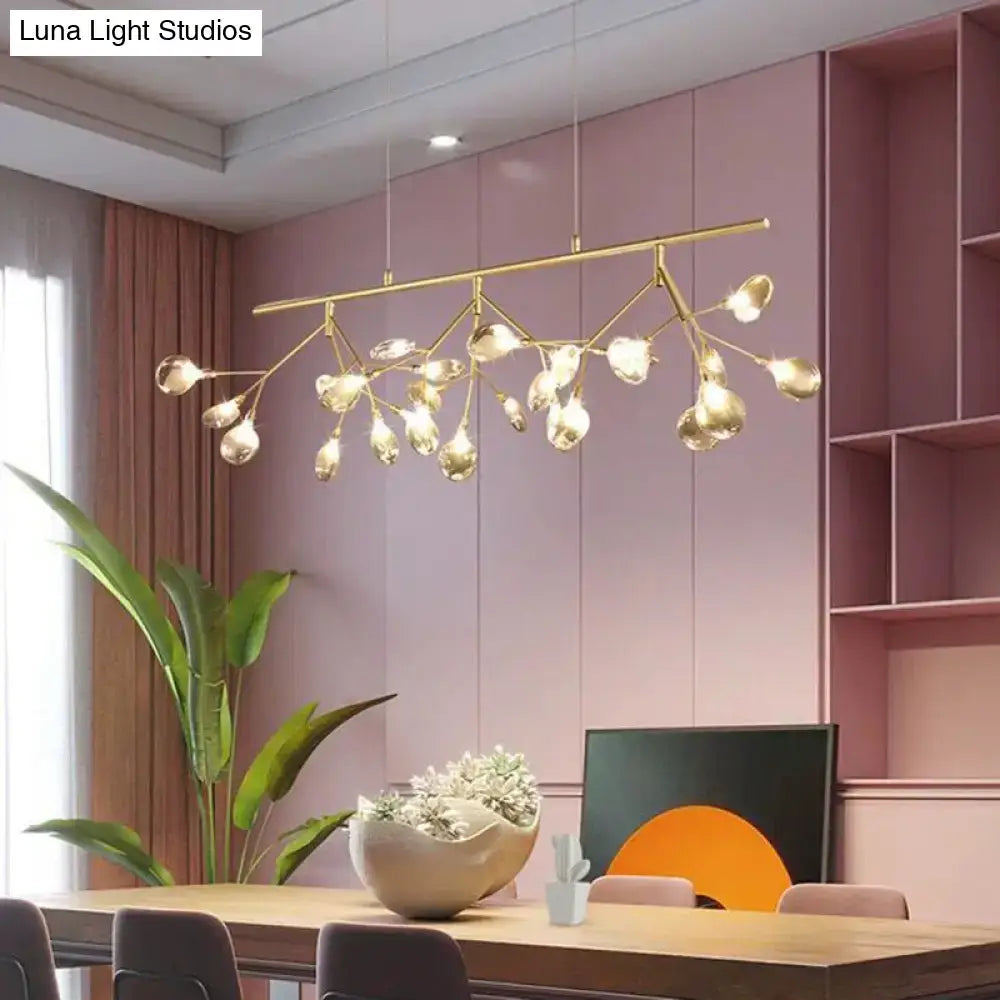 Modern dining room chandelier with gold-toned branching arms and clear glass globe bulbs