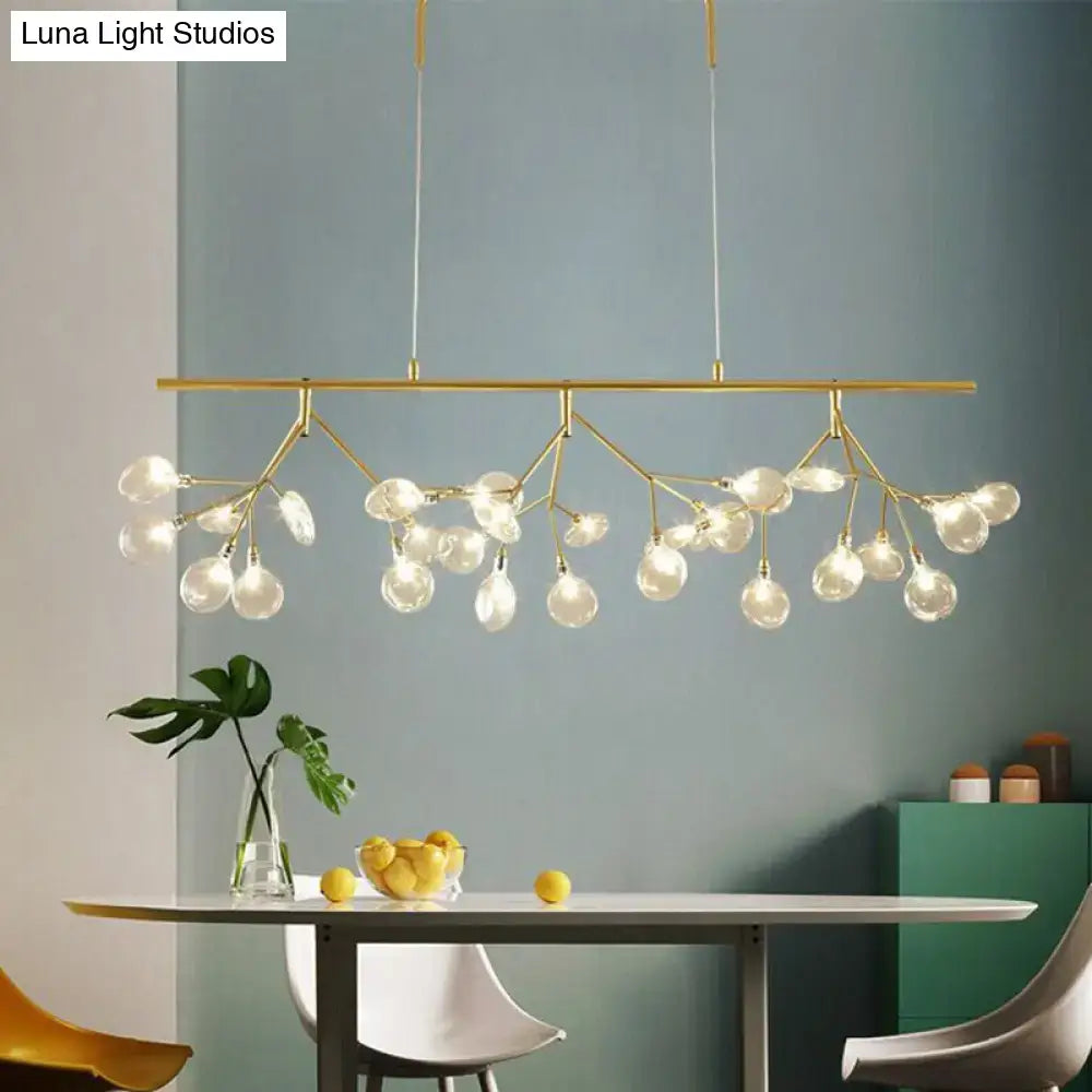 Modern black branching chandelier with gold-toned arms and clear glass globe bulbs for dining room lighting