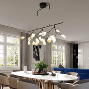 Modern black metal branching chandelier with frosted glass globe bulbs for dining room lighting