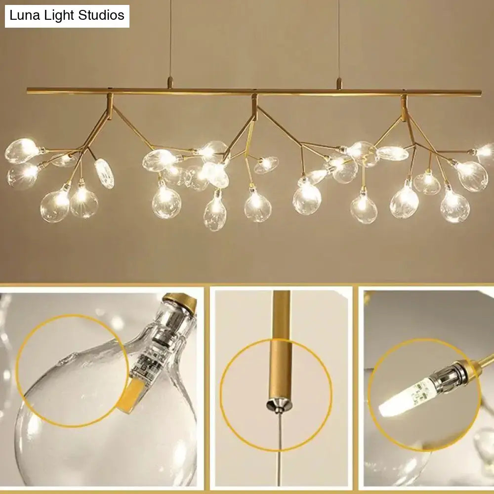 Modern black branching chandelier with gold-toned branches and clear glass globe bulbs for dining room lighting