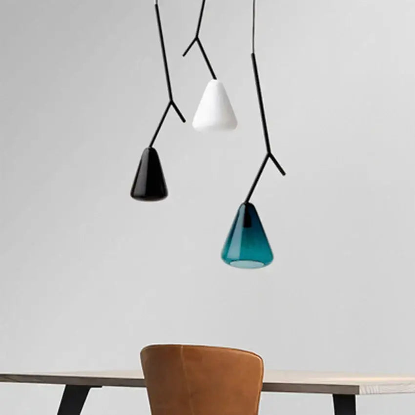 Three modern black branching glass pendant lights with conical shades in black white and teal for dining rooms
