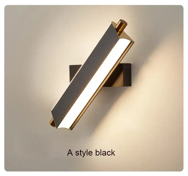 A sleek modern black and brass decorbites adjustable led wall lamp with a rectangular body for bedroom sconce lighting
