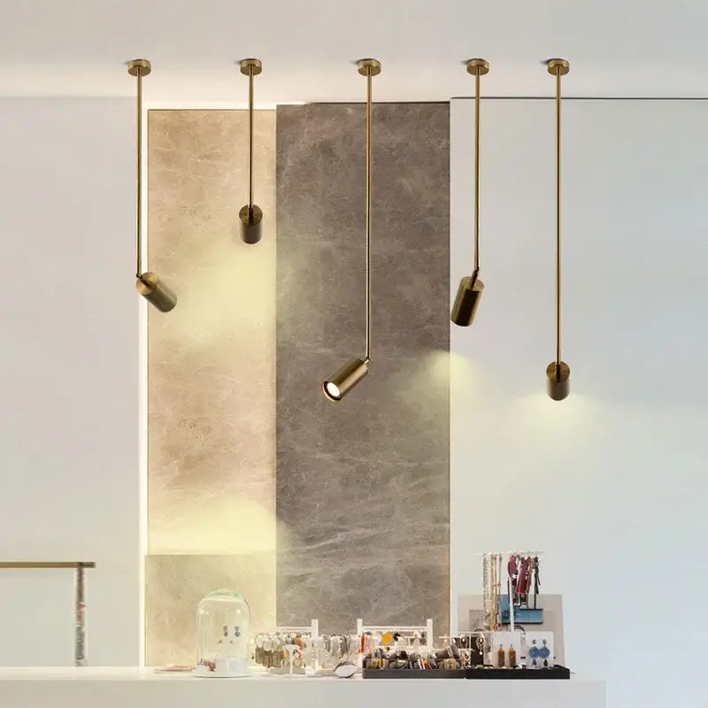 Five sleek black and brass pendant lights with adjustable directional light fit for gu10 led bulbs in a modern kitchen