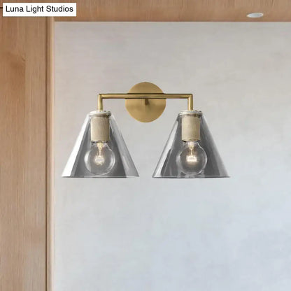 Modern black and brass wall light with two silver glass cone shades and exposed bulbs direct wired electric design