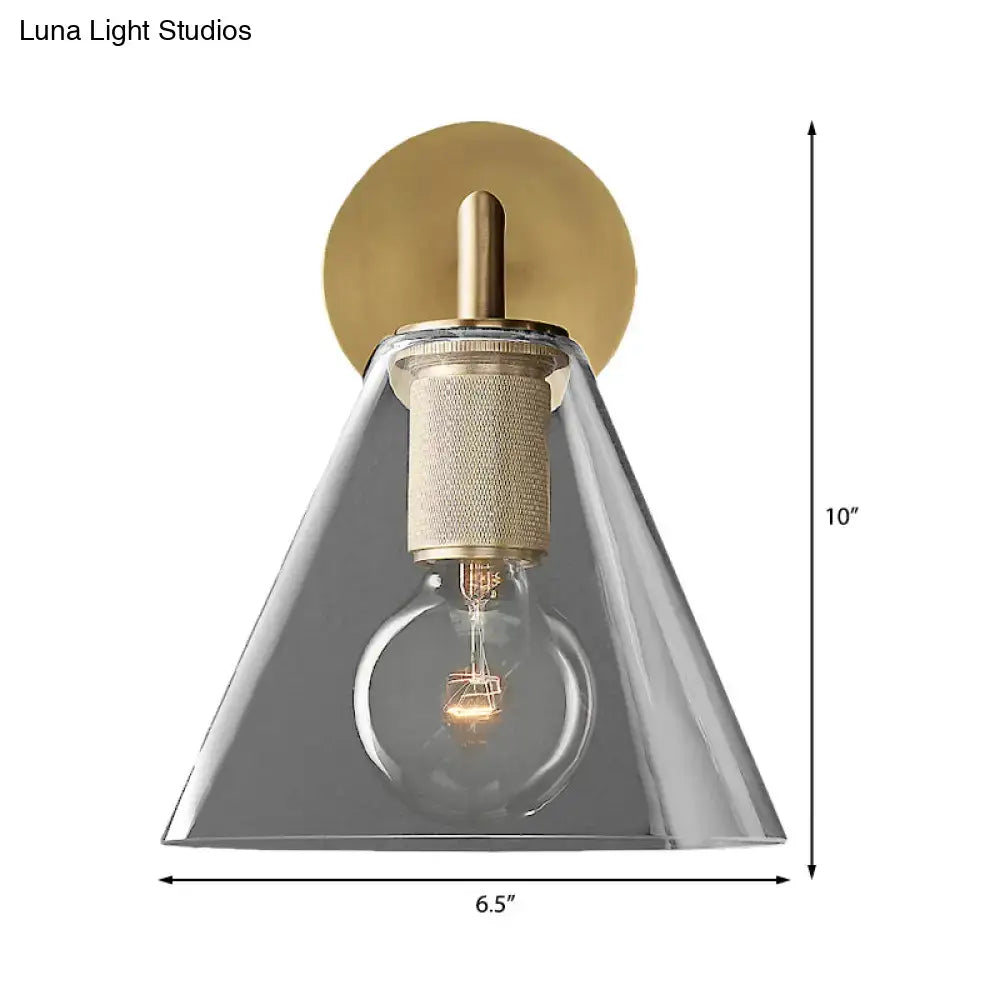 Modern black and brass direct wired electric wall light with clear glass cone shade and exposed filament bulb