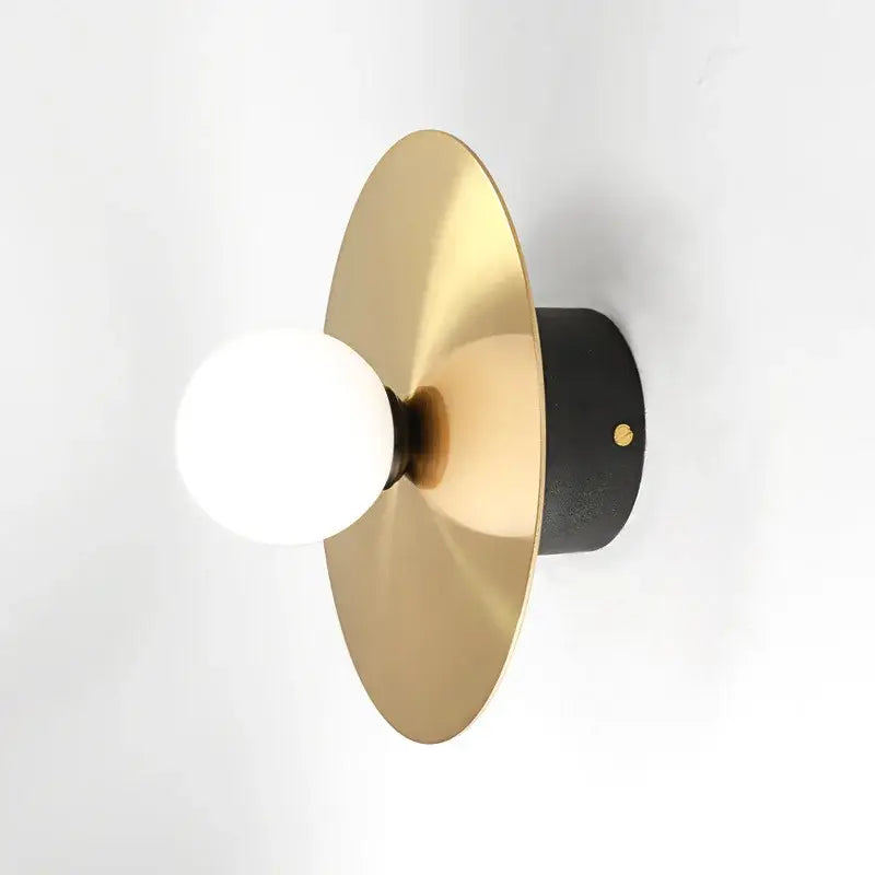 Modern black and brass golden glass ball wall sconce with brushed gold circular shade and white spherical bulb decorbites golden glass