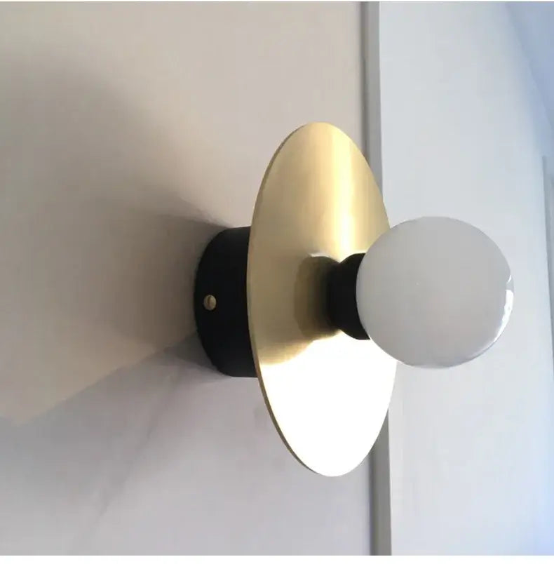 Modern black wall sconce with brass golden glass ball and frosted bulb by decorbites for bedroom lighting decor