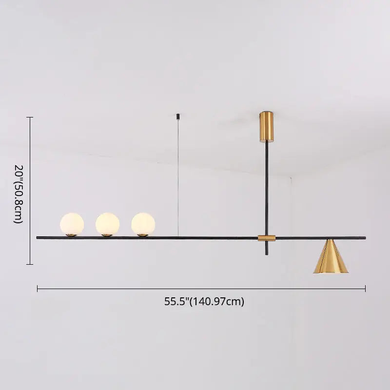 Modern black and brass linear chandelier with three spherical white glass bulbs and gold-toned metal accents
