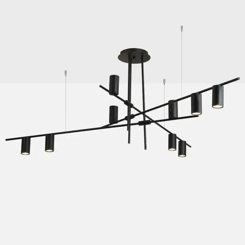 Modern black and brass minimalist dining room linear pendant light with black metal cylindrical fixtures in geometric pattern