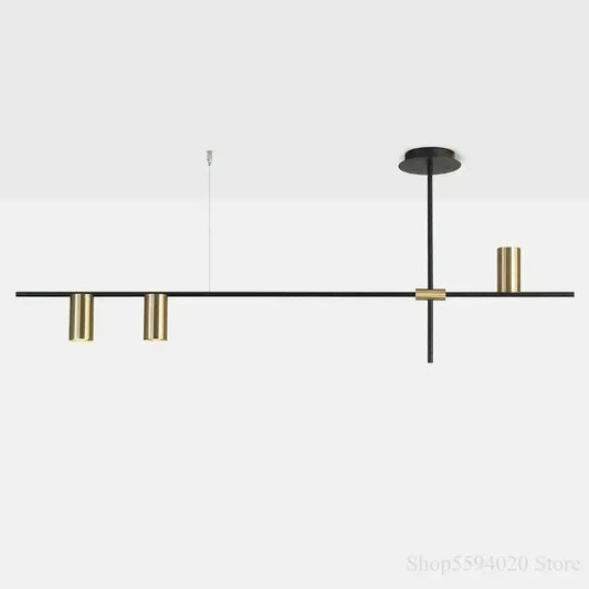 Modern black and brass minimalist linear pendant light with cylindrical fixtures for black minimalist dining decorbites