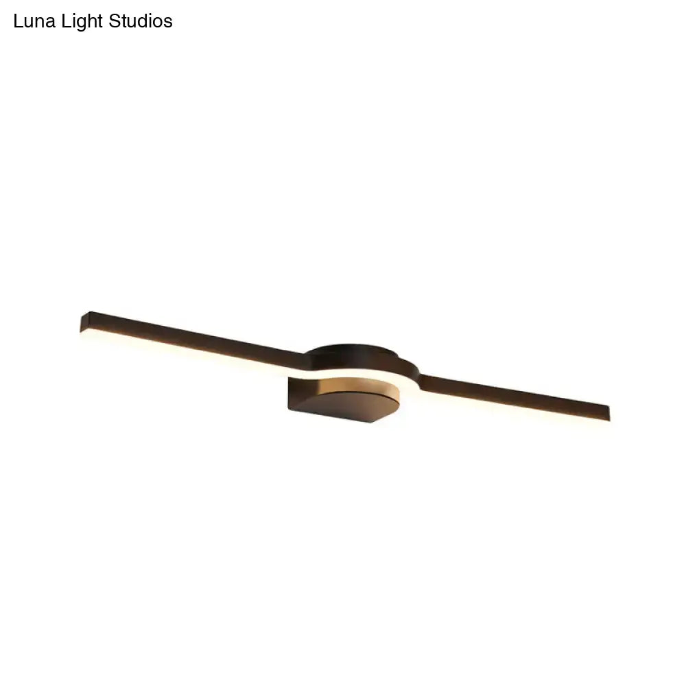 Modern black and brass slim line led vanity light with two elongated arms emitting white warm light for bathroom use