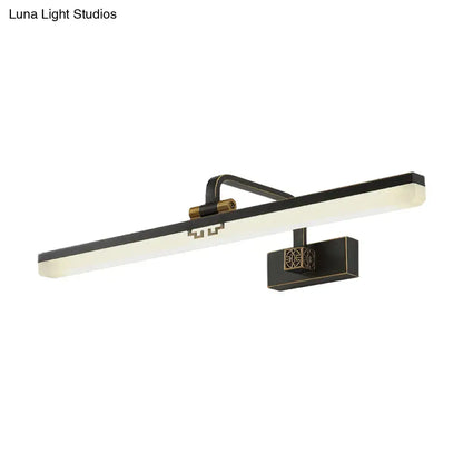 Modern black and brass wall vanity light with sleek rectangular light bar and ornate geometric bracket for metallic mirror