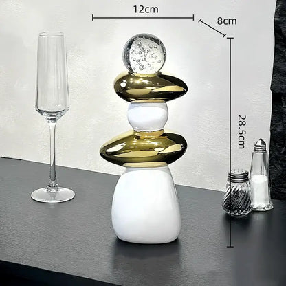 Modern black ceramic decorative crystal ball statue featuring sleek white and gold glossy orbs with a clear glass sphere on top