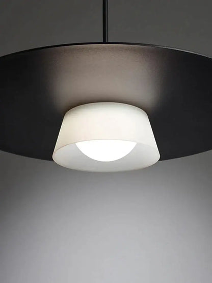 Modern black pendant light with matte circular shade and frosted glass for decorbites circular coffee shop decor