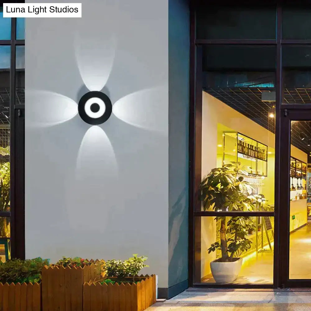 Modern black circular led outdoor wall sconce with four radiant light beams for garden and outdoor wall lighting