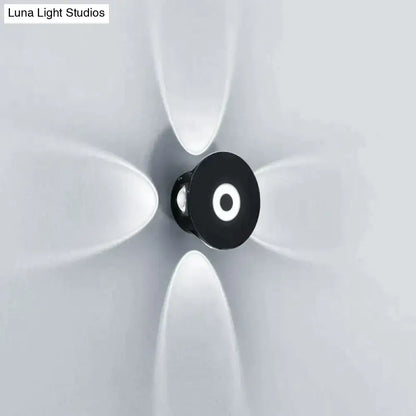 Modern black circular led outdoor wall sconce with glowing white ring designed for outdoor wall garden lighting