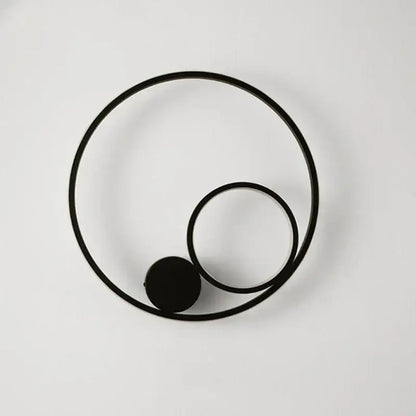 Modern black circular led wall lamp with minimalist concentric rings and spherical element for bedroom sconce