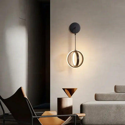 Modern black circular wall sconce light with a glowing ring design for bedroom sconce light use