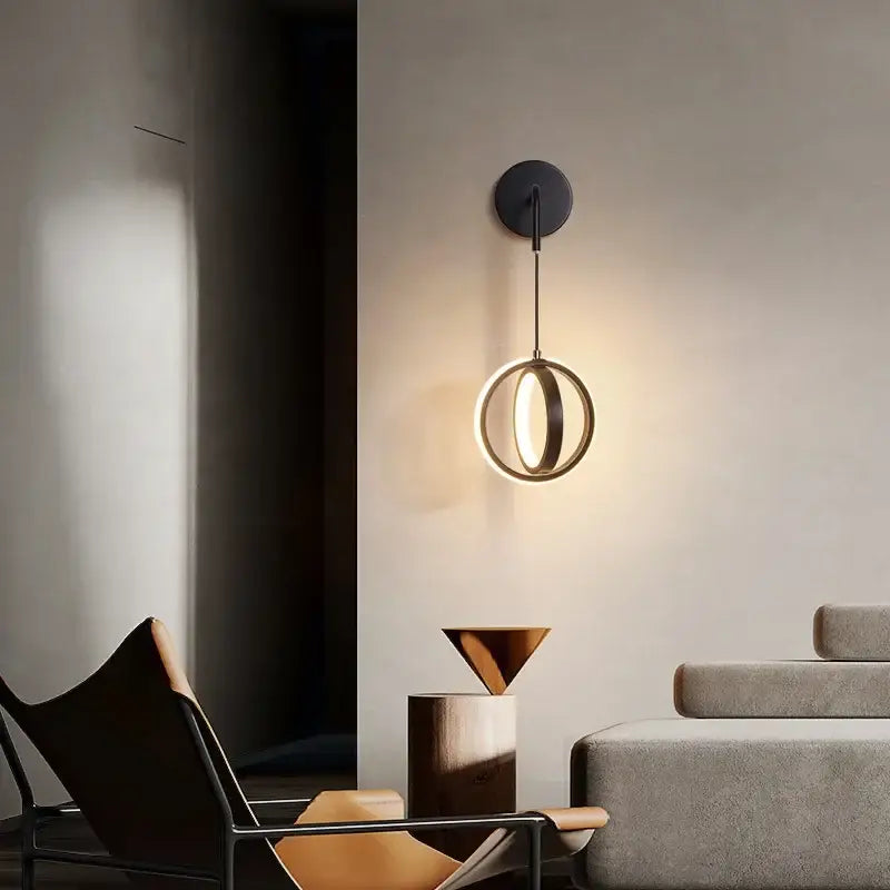 Modern black circular wall sconce light with a glowing ring design for bedroom sconce light use